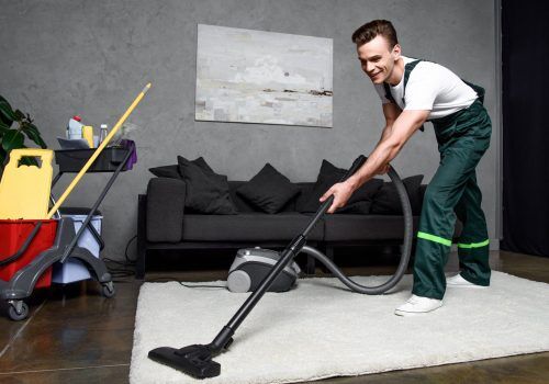 smiling-young-professional-cleaner-cleaning-carpet-2021-08-29-22-37-36-utc (1) Professional doing carpet cleaning work